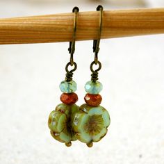 "This listing is for these vintage style, glass beaded, dangle earrings. They are wonderful mint green flower beads, orange brown, and a pale aqua with a touch of green. They are part of my coral pink and mint series. All the items from this series can mix and match. These earrings are 1.5 inches in length. They are light weight and comfortable. The smaller bead is 3 x 5mm in size, the Hibiscus flower bead is 12mm. This is available in a vintage look with antique brass (as shown), hypoallergenic Bohemian Glass Drop Earrings, Vintage Adjustable Jewelry With Dangling Beads, Vintage Czech Glass Matching Earrings, Adjustable Retro Drop Earrings, Adjustable Nickel-free Retro Earrings, Retro Adjustable Drop Earrings, Vintage Green Flower Earrings, Vintage Beaded Earrings With Ear Wire As Gift, Handmade Vintage Beaded Earrings With Round Beads