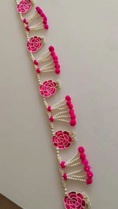 pink and white beaded bracelet with flowers on it