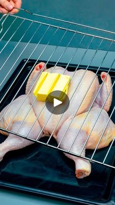 a person cutting up a piece of cheese on top of a chicken in an oven