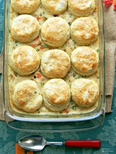 a casserole dish filled with biscuits and vegetables