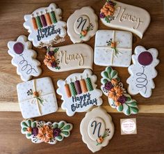 decorated cookies are arranged on a wooden table