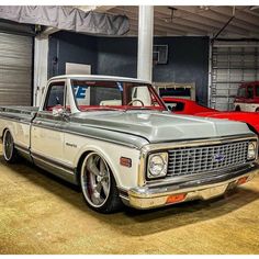 an old pickup truck parked in a garage