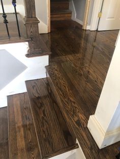 an open door and some stairs in a house with wood floors on either side of it