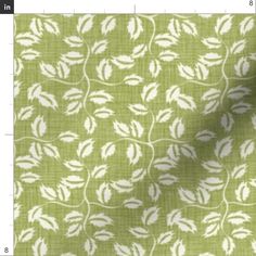 a green and white fabric with leaves on it