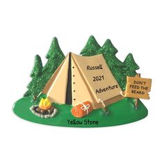 a christmas ornament with a tent and sign