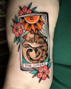 a woman with a tattoo on her arm has a picture of two cats and the sun