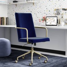 a blue office chair sitting in front of a desk