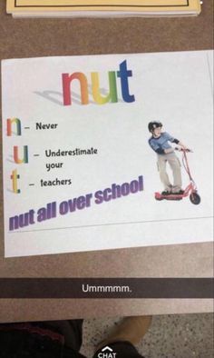 a person standing in front of a bulletin board with the words nut and an image of a boy on a scooter