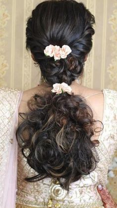 the back of a woman's head with flowers in her hair