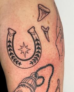 a close up of a person's arm with tattoos on it and other items