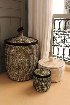 two baskets sitting next to each other near a window