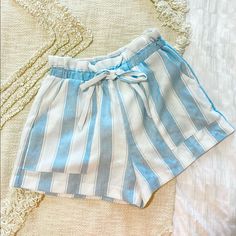 Cute Paper Bag Waist Shorts From Lush! The Light Blue And White Stripes Are So Classic And Cute! I Want To Keep These Shorts But I’ve Just Never Worn Them Since I Have A Similar Pair. Perfect Condition! Chic Light Blue Beach Bottoms, Chic Light Blue Bottoms For Vacation, Blue Bottoms For Spring And Summer Outings, Chic Light Blue Shorts For Day Out, Chic Blue Bottoms For Beach Season, Blue High-waisted Pajama Shorts For Spring, Light Blue Beach Bottoms With Built-in Shorts, Striped Pajama Shorts With Built-in Shorts, Striped Cotton Bottoms With Built-in Shorts