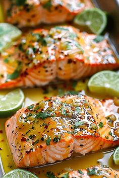 two salmon fillets with lime slices and seasonings