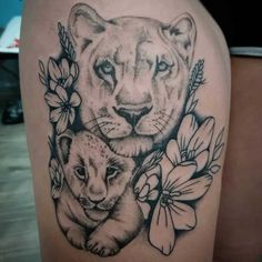 a woman's thigh with an image of a lion and cub in the center