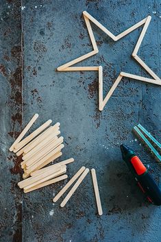 wooden sticks and glue are arranged in the shape of a star