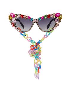 Prepare to exude glamour with these rhinestone face sunglasses, ensuring you feel effortlessly fabulous! Crafted with plastic frames these flamboyant cat-eye shaped polycarbonate lenses feature all-over hand embellishment with firmly applied, prong-set rhinestones.  From light to dark tinted lenses, these sunglasses also feature colorful removable plastic chain neck straps that perfectly match the stems. Each pair is as unique as you are, with assorted stones and chain links, guaranteeing you'll Dramatic Sunglasses, Carnival Parade, Rhinestone Face, Eye Wear, Cool Sunglasses, Neck Chain, Eye Shapes, Neck Strap, Bold Prints