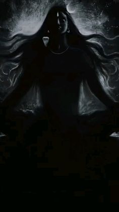 a woman with long hair standing in the dark