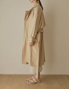 A cool variation of the classic trench, the Lotte Trench features a relaxed, slouchy silhouette with cinchable waist and wrists, rounded shoulders, and deep patch pockets. Also available in dark beige. - Overcut- Pointed collar- Top button closure- Half storm front and back- Removable storm neck piece- Belted waist and cuffs- Angled patch pockets- Back vent- Fully lined- Measurements Length 45.5", Bust 52", Sleeve 31.5"- Outer: 100% Cotton, Lining: 100% Polyester- Dry clean- Imported Trench Lighter, Rounded Shoulders, Storm Front, Neck Piece, Dark Beige, Collar Top, Light Beige, Horn, Duster Coat