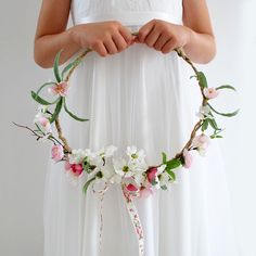 a woman wearing a flower crown with flowers on it