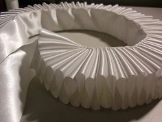 a white paper plate sitting on top of a table next to a napkin covered cake