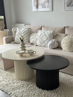 a living room filled with furniture and pillows on top of a white carpeted floor