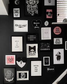 a black wall covered in lots of different types of pictures and stickers on it