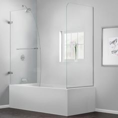 a white bathroom with a glass shower door