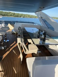 the interior of a boat with tables, chairs and bottles on it's deck