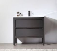 a bathroom vanity with two drawers and a white rug on the floor next to it