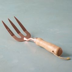 a wooden fork and knife laying next to each other