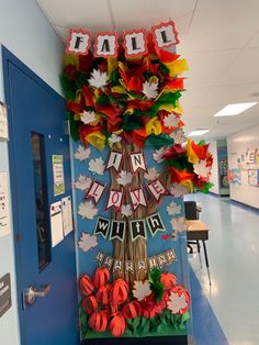 a decorated tree in the middle of a hallway with decorations on it and letters that spell out fall