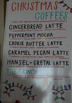 the menu for christmas coffees is displayed on a white board with colorful lettering and decorations