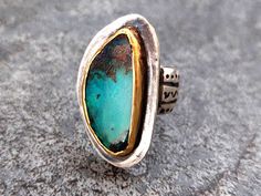 An enchanting Opal gemstone ring handmade in solid Sterling Silver and 22K yellow Gold.  The ring is truly special with a beautiful natural Blue-Green Australian Boulder Opal stone which was bezel set in 22k hammered yellow solid Gold. It has a thick  backing of 1.2 millimeters. The shank is a wide carved textured silver band.  The collaboration of the metals and stone produces a delightful organic ring. It is said of Opal stones  that they enhance creativity, help to calm emotional experiences Artisan Rings With Bezel Setting, Unique Emerald Ring With Bezel Setting Gift, Artisan Handmade Emerald Ring For Anniversary, Handmade Artisan Emerald Ring For Anniversary, Unique Emerald Ring For Anniversary, Unique Emerald Ring With Stone Setting For Anniversary, Artisan Opal Ring For Anniversary, Unique Handmade Gold Emerald Ring, Unique Opal Ring For Anniversary With Stone Setting