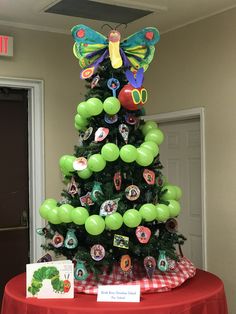 a christmas tree decorated with balloons and magnets for the very hungry caterpillar