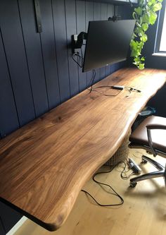 a wooden desk with two monitors on it