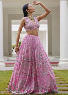 This modern lehenga in pastel hues features geometric and floral prints highlighted with embroidery detailing. The blouse comes with a deep V neckline adorned with beads and sequins all over. A cape with gathers is added to give you that chic look in an ethnic wear. Semi-stitched Pink Choli With Floral Embroidery, Floral Pink Lehenga, Pink Embellished Semi-stitched Choli, Transitional Pink Embroidered Lehenga, Pink Floral Embroidered Semi-stitched Lehenga, Modern Lehenga, Embroidery Detailing, Custom Tailoring, Pastel Hues