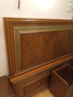 a wooden headboard with an intricate design on it