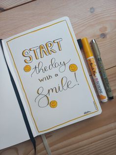 an open notebook with the words start the day with a smile