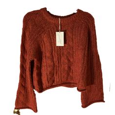 Elevate your winter and fall wardrobe with this Universal Thread from Target Women's Cable Knit Crewneck Sweater. The tag says the color is red BUT this is not a true red. More of a brownish oranges red. The sweater features a beautiful loose cable-knit pattern with bell sleeves and a rolled hemline for a chic and modern touch. The warm cozy soft heavyweight sweater is made of a knit fabric of polyester and acrylic, making it comfortable to wear while keeping you warm in colder weather. Raglan sleeve with bell and rolled cuffs. Oversized. This sweater is perfect for casual occasions and can be styled with jeans and sneakers. The sweater is machine washable, and the size is regular fit. MSRP $30 Please follow as I add additional women’s sweaters in various sizes, styles, and colors separate