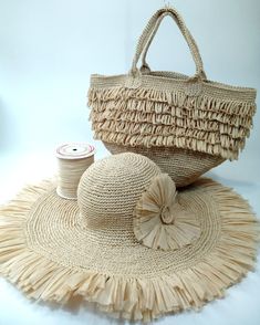 a straw hat and bag sitting on top of a table