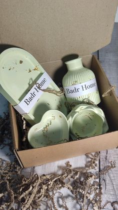 a box filled with green pottery sitting on top of a table