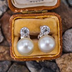 These elegant vintage 18k white gold earrings each feature a post set, cultured saltwater pearl, topped by a round old European cut diamond in a platinum bezel setting. The earrings measure 15.6mm long and are finished with non- pierced screw backs. Classic Platinum Pearl Earrings For Formal Occasions, Classic Silver Platinum Pearl Earrings, Classic White Gold Pearl Earrings, Elegant Platinum Pearl Earrings For Formal Occasions, Classic Clip-on Diamond Earrings, Luxury Platinum Pearl Earrings For Wedding, Elegant Platinum Pearl Earrings For Wedding, Classic Hallmarked Diamond Earrings For Formal Occasions, Classic Hallmarked Diamond Earrings For Formal Events