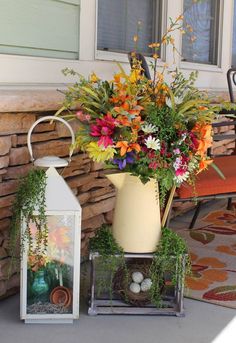 a vase filled with flowers next to a lantern