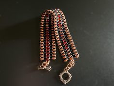 I love the look of mixed metal colors and this has gold, copper and bronze.  Three rows of super duo beads outlined with dark brown delica beads, with a bronze colored toggle clasp.  The length from end to end is 7 1/2" and is 1" wide.  As is, it will fit a 6 3/4" wrist.  Additional jump rings can be added for more length. Beaded Bronze Copper Bracelets, Bronze Beaded Copper Bracelets, Brown Copper Beaded Bracelets With Round Beads, Superduo Bracelet, Super Duo Beads, Duo Beads, Copper Red, Delica Beads, Jump Rings