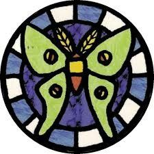 a stained glass window with a butterfly on it's back and two eyes in the center