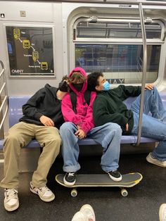 two people are sleeping on a subway bench