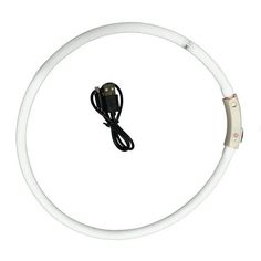 a white circular light with a black cord