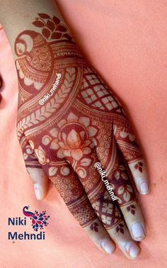 the hand is decorated with henna and flowers