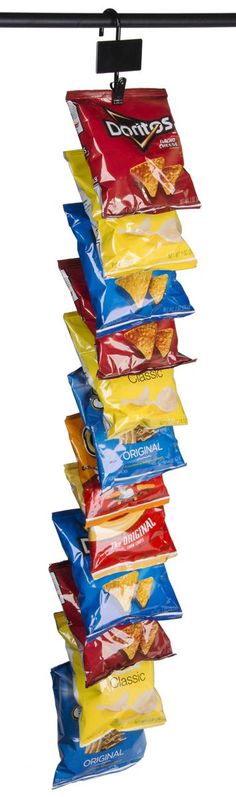 several bags of chips are hanging from a black metal hook on a white background,