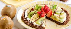 a kiwi fruit tart is on a plate with two pieces cut out and ready to be eaten